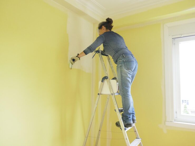 woman-ladder-painting-yellow-wall-white-with-paint-roller_1048944-13309204